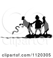 Clipart Of A Silhouetted Man Dropping An Eel Into The Water Royalty Free Vector Illustration by Prawny Vintage