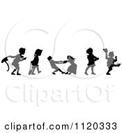 Clipart Of Silhouetted Children Playing Royalty Free Vector Illustration