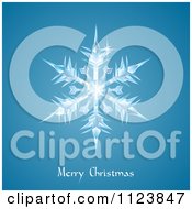 Clipart Of An Icy Snowflake Over Merry Christmas Text On Blue Royalty Free Vector Illustration