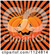 Cartoon Of A Grinning Jackolantern Halloween Pumpkin Over Grungy Rays Royalty Free Vector Clipart