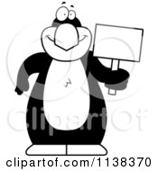 Cartoon Clipart Of An Outlined Penguin Holding A Sign Black And White Vector Coloring Page