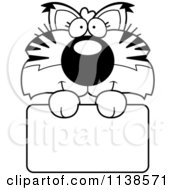 Cartoon Clipart Of An Outlined Cute Bobcat Cub Over A Sign Black And White Vector Coloring Page