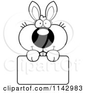 Cartoon Clipart Of A Black And White Cute Bunny Holding A Sign Vector Outlined Coloring Page