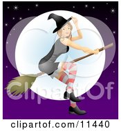 Young Witch Flying On A Broomstick In Front Of The Moon