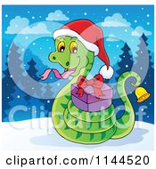 Cartoon Of A Cute Christmas Snake Ringing A Bell And Holding A Gift In The Snow Royalty Free Vector Clipart