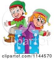 Cartoon Of Happy Christmas Elves Sitting On A Gift Box Royalty Free Vector Clipart