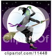 Ugly Witch Flying On A Broomstick In Front Of The Moon