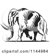 Clipart Of A Retro Black And White Walking Wooly Mammoth Royalty Free Vector Illustration