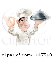 Cartoon Of A Happy Chef Gesturing Okay And Holding A Platter Royalty Free Vector Clipart