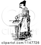 Clipart Of A Retro Vintage Black And White Woman Ironing Royalty Free Vector Illustration