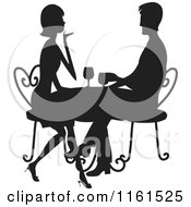 Silhouetted Couple Drinking Wine At A Table