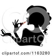 Cartoon Of A Silhouetted Woman Applying Red Liptstick Royalty Free Vector Clipart