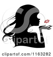 Silhouetted Woman Blowing A Red Kiss