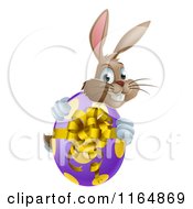 Cartoon Of A Brown Bunny Hugging A Polka Dot Easter Egg Royalty Free Vector Clipart