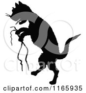Clipart Of A Silhouetted Cat With Strings Royalty Free Vector Illustration