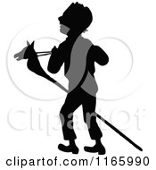 Poster, Art Print Of Silhouetted Boy With A Stick Pony