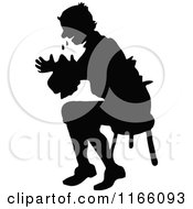 Silhouetted Man Crying And Sitting In A Chair