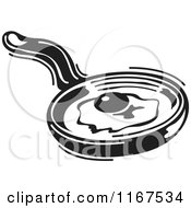 Clipart Of A Black And White Retro Egg Cooking In A Skillet Royalty Free Vector Illustration by Andy Nortnik