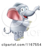 Cartoon Of A Happy Elephant Standing And Pointing Royalty Free Vector Clipart