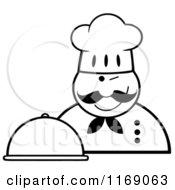 Cartoon Of A Happy Black And White Chef Holding A Cloche Platter And A Winking Royalty Free Vector Clipart