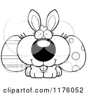 Cartoon Of A Black And White Happy Easter Bunny With Eggs Royalty Free Vector Clipart