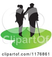Poster, Art Print Of Silhouetted Caring Nurse Walking With A Man And A Cane On A Green Heart