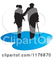 Silhouetted Caring Nurse Walking With A Man And A Cane On A Blue Heart