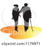 Silhouetted Caring Nurse Walking With A Man And A Cane On An Orange Heart