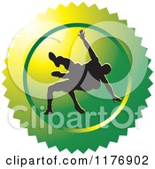 Clipart Of A Green Wrestling Logo With Silhouetted Wrestlers Royalty Free Vector Illustration