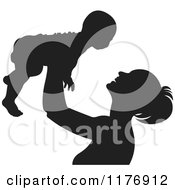 Clipart Of A Nurturing Silhouetted Mother Holding Up A Baby Royalty Free Vector Illustration
