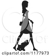 Cartoon Of A Stylish Silhouetted Woman Walking With Her Puppy Royalty Free Vector Clipart
