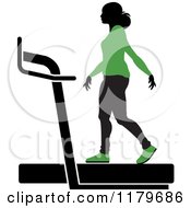Poster, Art Print Of Silhouetted Woman In A Green Outfit Walking On A Treadmill