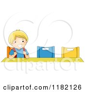 Happy Blond School Boy Sitting At A Desk Alone