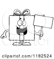 Cartoon Of A Black And White Gift Box Mascot Holding A Sign Royalty Free Vector Clipart