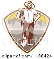 Clipart Of A Retro Gold Miner Man Standing With A Shovel In A Mountain And Sunshine Shield Royalty Free Vector Illustration