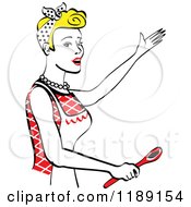 Poster, Art Print Of Happy Retro Blond Housewife Singing And Holding A Spoon In The Kitchen