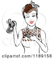 Happy Retro Brunette Woman In An Apron Holding Up A Bottle Of Cooking Oil