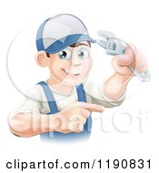 Cartoon Of A Happy Brunette Worker Man Holding A Wrench And Pointing Royalty Free Vector Clipart