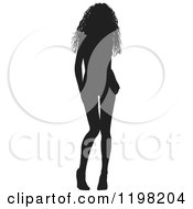 Clipart Of A Sexy Black Silhouetted Woman With Loose Curly Hair Wearing Heels And Tilting Her Knees Inward Royalty Free Vector Illustration