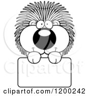 Cartoon Of A Black And White Cute Happy Porcupine Over A Sign Royalty Free Vector Clipart