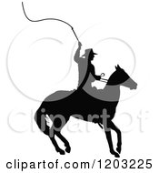 Clipart Of A Black Silhouetted Horseback Cowboy Swinging A Whip Royalty Free Vector Illustration