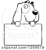 Cartoon Of A Black And White Cute Hound Dog Over A Sign Royalty Free Vector Clipart