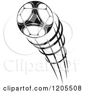 Clipart Of A Black And White Flying Soccer Ball 2 Royalty Free Vector Illustration