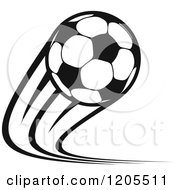 Clipart Of A Black And White Flying Soccer Ball Royalty Free Vector Illustration