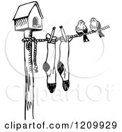 Clipart Of A Black And White Bird House With Birds And Socks On A Clothes Line Royalty Free Vector Illustration