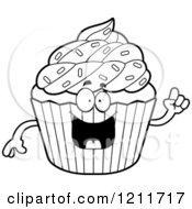 Cartoon Of A Black And White Smart Sprinkled Cupcake Mascot With An Idea Royalty Free Vector Clipart