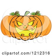 Cartoon Of A Trio Of Halloween Pumpkins Royalty Free Vector Clipart