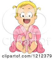 Happy Blond Toddler Girl Sitting In A Pink Bath Robe
