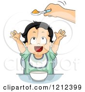 Hand Holding Baby Food In A Spoon Over A Toddler Boy