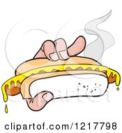 Hand Holding A Mustard Topped Hot Dog